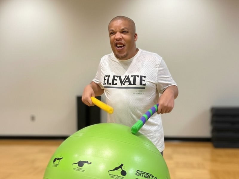 Group cardio drumming session with adaptive recreation